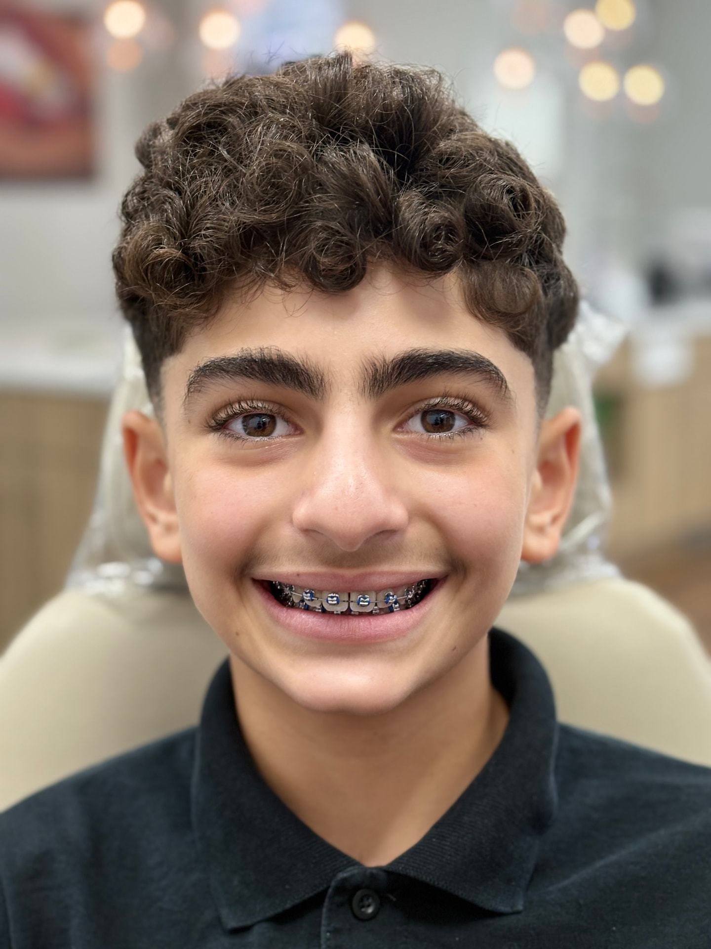 Braces patient smiling in the NA Orthodontics office