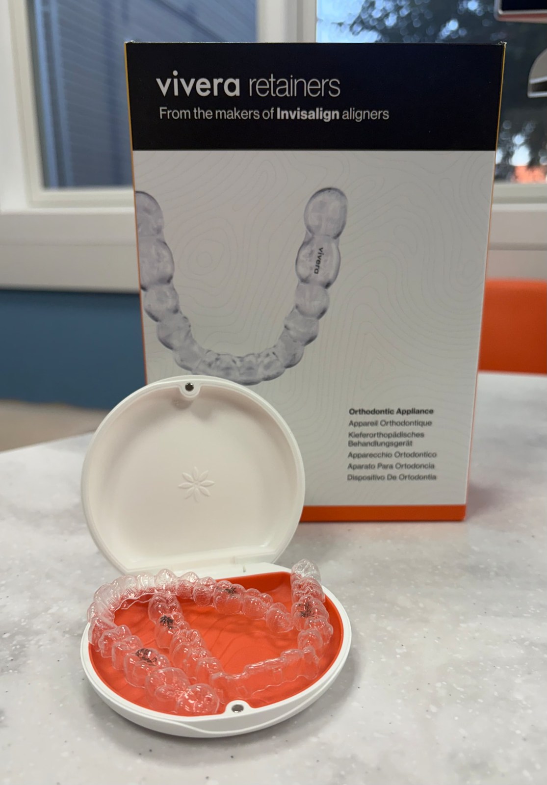 Vivera retainer packaging and an open retainer case at the orthodontic office