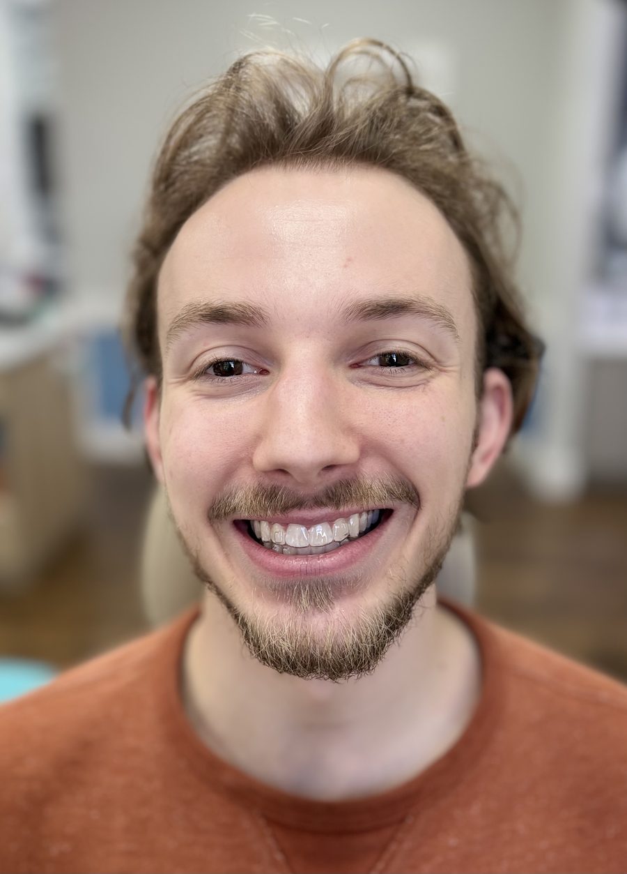 Patient showing a new smile after orthodontic treatment